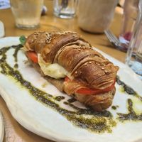Croissant with vegan cheese, tomato and pesto at La Papa in Barcelona