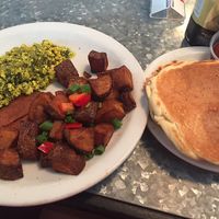 pesto tofu scramble, vegan bacon, home fries, and pancakes - all for $10! at Downbeat Diner and Lounge in Honolulu