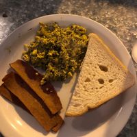 Vegan Scramble w/ bacon and toast. Not super flavorful but still good  at Downbeat Diner and Lounge in Honolulu