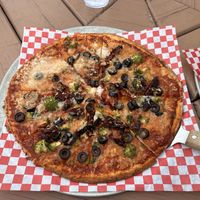 Gluten free base, vegan cheese, olives, sun-dried tomato and broccoli   at Rising Sun Pizza Company in St Mary