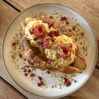 Pistachio Croissant! Delicious! Vegan croissant filled with cream, topped with raspberries and pistachio 🥐🧁  at Sama Sama Veggie in Salou