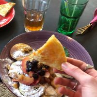 Cheese naan with pancakes in background  at Little World Kitchen in Utrecht