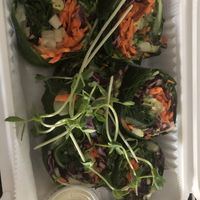 Raw veggie wrap - shredded cabbage, carrots, cucumber, avocado, sprouts, vegan tahini, wrapped in a collard green   at bee-ORGANIC in Great Neck