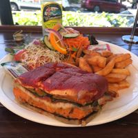Slice of vegan lasagna with chips and salad at Shali's Cafe in Montville
