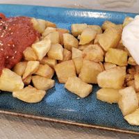 Patatas braviolis at Sidrería As de Guía in Llanes