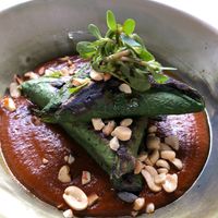 Tételas de maíz azul with mole, wrapped in hija santa, stuffed with beans at Tata Mezcaleria in Morelia