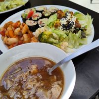 Plate of the day with mushroom-miso soup, steamed veggies marinated with extravirgin olive oil and lemon, traditionally cooked giant beans, "greek vegan sushi", Caesar salad. Fanta at Demetra in Chalkis