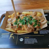 Homemade fries from fresh potatoes with cheddar and champignonsauce. The potatoes are from a local farmer.  at Frittenglück  in Koblenz