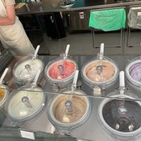 Vegan flavors are: front left (mango), front right (dark choc, back left to right (lemon, strawberry, peach). at Gelateria Villi in Olbia