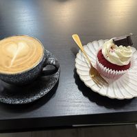 Oat milk flat white and a red velvet cupcakee  at Mudita in Auckland