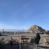 Outdoor seating with view of morro rock at Frankie & Lola's in Morro Bay