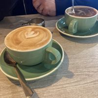 Americano with oat milk (background) Vanilla Oat Milk Latte (foreground )  at Brew + Bake in Preston