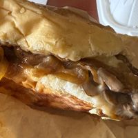 Benny’s cheesesteak burger (burger topped with steak, mushrooms, caramelized onions, jalapeños, mayo, and mozzarella) at Loving Hut - Mira Mesa in San Diego