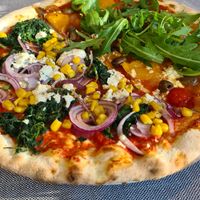 Both vegan pizzas cut in half at Lodenwirt in Obervintl