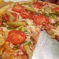 Pizza with tomato, artichoke, sweet onion, green peppers, and Follow Your Heart cheese. at Mellow Mushroom in Fredericksburg