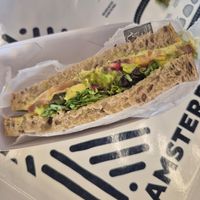Sandwich with avocado, hummus, pomegranate at AMS - Amsterdam Bread Company in Schiphol