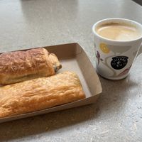Mushroom roll and pain au chocolate with oat latte  at AMS - Amsterdam Bread Company in Schiphol