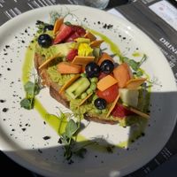 Avocado toast with vegetables, fruits, and vegan cheese   at EK Bistro in Ljubljana