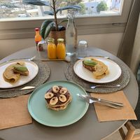 Vegan breakfast: Freshly squeezed orange juice, homemade bread with avocado, chickpea flour "omelette" with mushrooms & hazelnut chocolate pancakes with banana at Mod Santorini in Santorini
