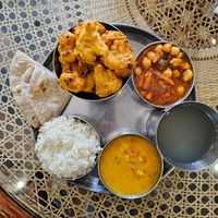 Daal, chickpea in tomato sauce, cauliflower in batter deep-fried, rice, lemon and ginger drink, and Chapatti at Govindas in Almaty