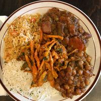 Clockwise from bottom left = Basmati Rice; Vegetable Fried Rice; Garden Vegetable Curry; Chana Masala. Middle = Mixed Vegetable Pakora at The Hyderabad Indian Grill in Bloomington