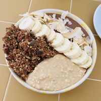 Delicious chocolate smoothie bowl with peanut butter, banana, coconut flakes and granola.  at Banacado in Stockholm