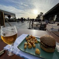 Vegan burger 10,20€ apr2023 + 1,80€ potatoes. Basil hummus, spinach, sundried tomatoes, crispy onions. Good burger😄had corn in it  at Ananda in Castelldefels