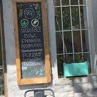 Sign by door outlining vegan options   at Café Raíz in Santiago