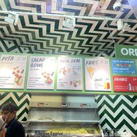 Sign shows price for extra ingredients, but it didn’t work that way.   at Maoz - Damrak in Amsterdam