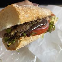 Baguette with olive tapenade, sprouts, carrots, lettuce, tomato, onion, eggplant  at City Market in Burlington