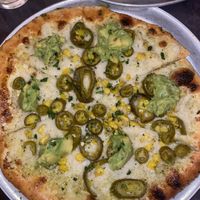 Pizza with vegan cheese, crust is vegan, avocado, corn, and pickled jalapeños (weird but amazing)  at Oak & Stone in Naples