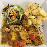 My meal - four thin slices of tofu cooked in oil, some potatoes and a tiny salad. But swimming in oil    at Vegetariano El Calafate in Malaga