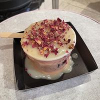 Apple crumbs with hot custard and rose petals on the top  at Humble Crumble in South East London