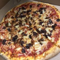 Pizza with Violife cheese, plant-based chorizo, black olives, and pineapple   at Pizza Pizza in Toronto