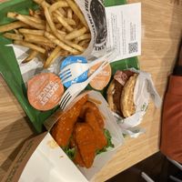 Chicken & waffle sandwich with fries and buffalo wings.  at Plant Power Fast Food - Craig Rd in Las Vegas