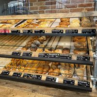 Dark green logo next to the name is vegan  at Backstube Bergen in Bergen