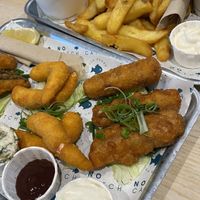 Chips, peas, vegan cod, vegan lemon shrimp, and sausages  at The No Catch Co in Brighton