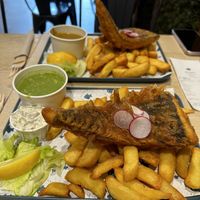 Large portion of “Cod” & chips with mushy peas😍 the curry sauce is unreal too!  at The No Catch Co in Brighton