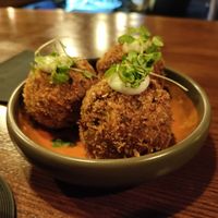 Mac n cheese balls on harissa sauce. So good at Speak In Code in Manchester