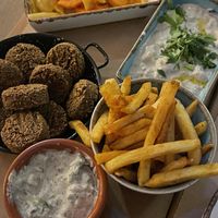 falafel with tzatziki sauce, fries, babaganoush and pickled veggies  at Tel Aviv Urban Food in Warsaw