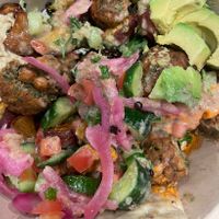 A bowl w/so much… falafel, pickled onion, pita...  at CAVA in Lancaster