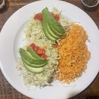 Sopes with beans, lettuce, tomatoes, avocado, and salsa comes with rice. Delicious !  at Rudy's in Santa Barbara