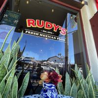Outside seating, with colorful flowers everywhere   at Rudy's in Santa Barbara
