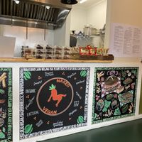 Cute art, and a selection of cakes.  at Naked Vegan in Greenville