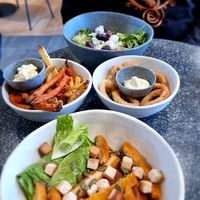 Greek bowl, cesar bowl, fries and onion rings at Copper Branch in Utrecht