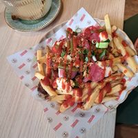 Loaded Rendang Fries —
Spicy and warming, with crispy skin-on fries, 
homemade rendang with Impossible® steak bites, 
creamy aiolinaise and a hint of sriracha. at Copper Branch in Utrecht