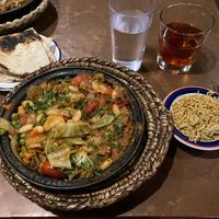 Cabbage with potato, peas, and carrots tagine with pita and rice. Also pictured is the Marakesh Sunset (May contain honey, not sure) alcoholic beverage which is strong and deli    at Tara Kitchen in Albany