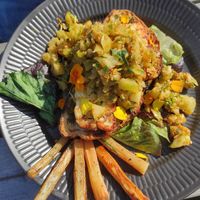 Roasted bread with vegan cheese and 'salad' of green tomatoes on top. at Sono Matseljur in Reykjavik