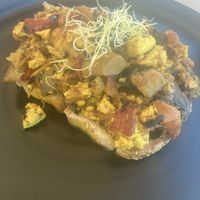 Tofu scramble ( more like a shakshuka(?)) lots of veg , quite oily but I like that ! Lovely seeded bread   at Come Back in Naoussa