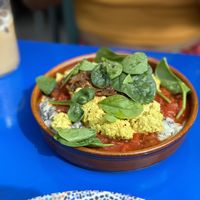 Creamy scramble and Taktouka on a Esfenaj Borani with caramalized onions and almond crackers  at DAR Restaurant & Cocktail Bar in Zurich